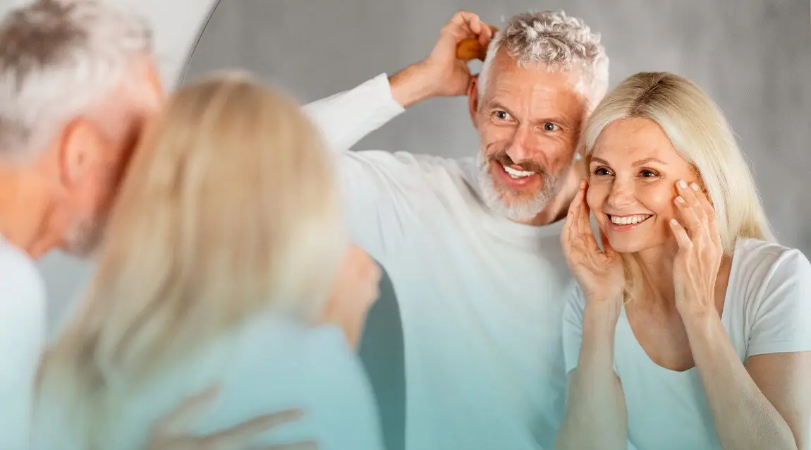 Adultos de mediana edad mirándose al espejo.